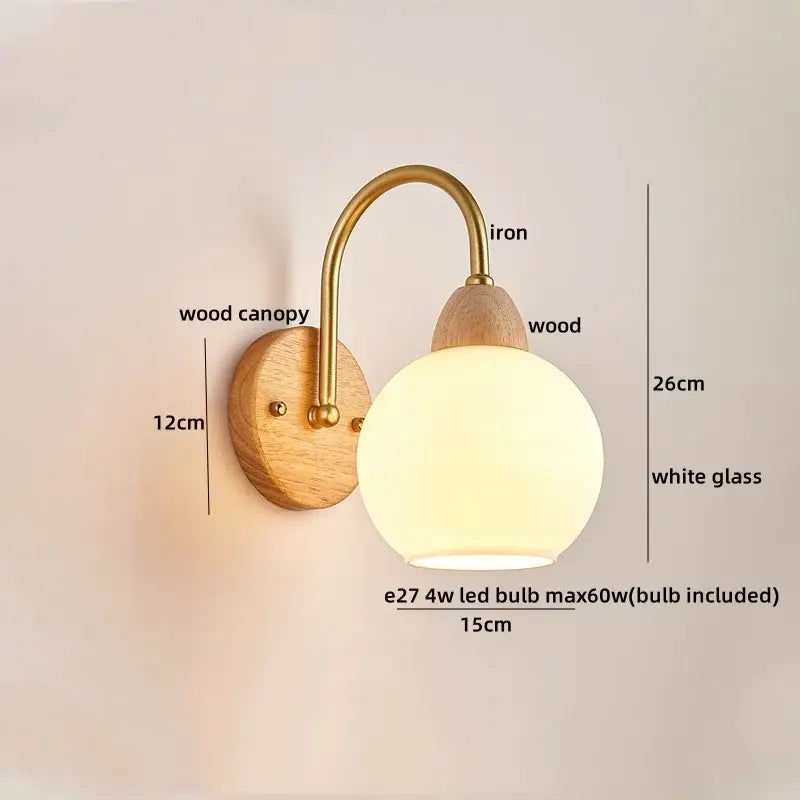 A warm-toned decorbites cotton led wall lamp with brass iron arm wooden base and frosted glass globe cloud sconce