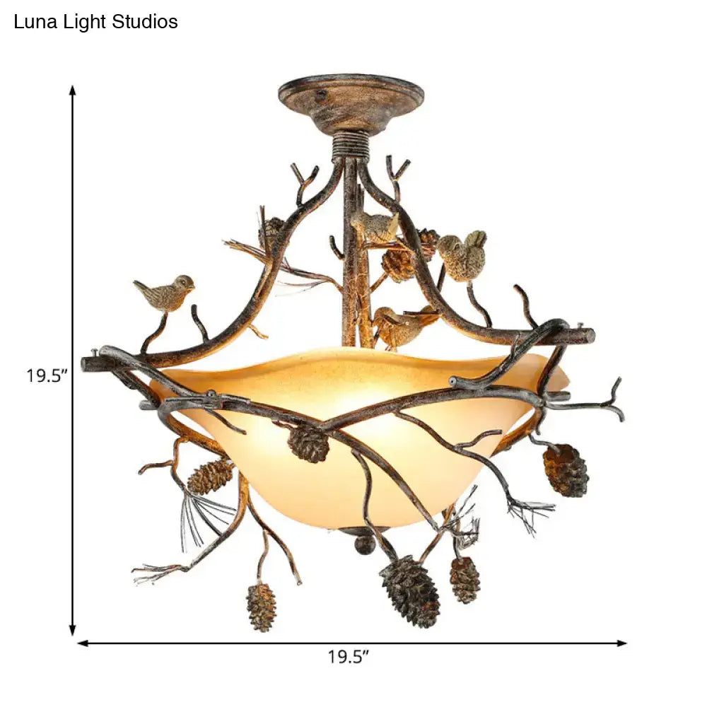 Rustic bronze finish decorbites semi flush ceiling light with intricate branch pinecone bird design and warm amber bowl shade