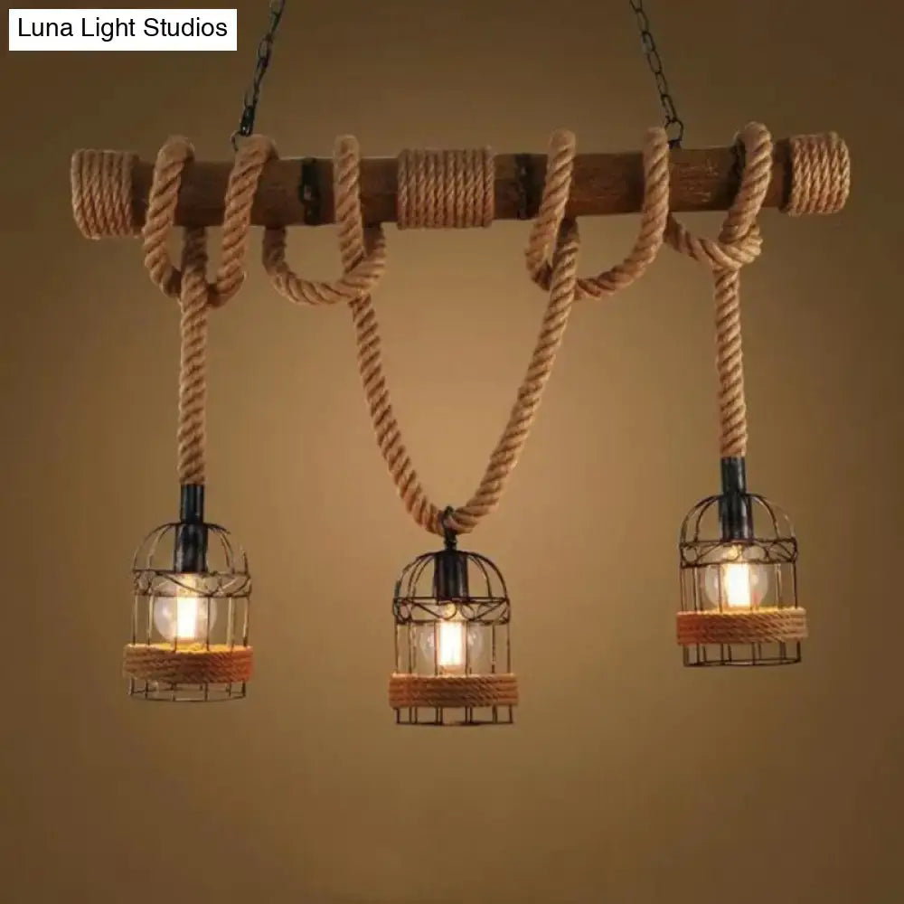 Rustic industrial-style bamboo hanging lamp with wooden beam, beige hemp rope, and three cage pendant lights for restaurants