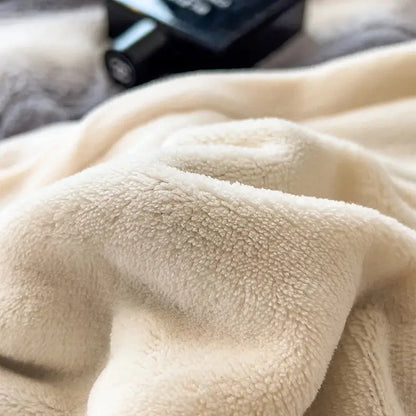 Cream-colored plush fleece blanket with soft textured surface as part of decorbites cozy faux fur gray white bedding set