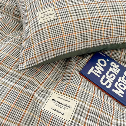 Plaid-patterned pillow with gray white and orange check design from decorbites cozy nordic plaid queen king bedding set