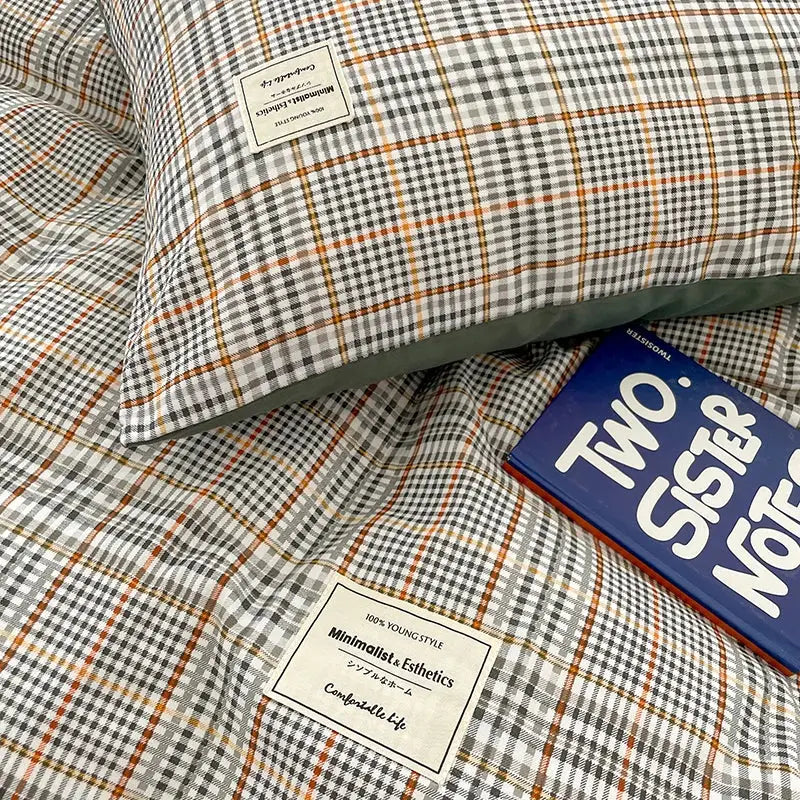 Plaid-patterned pillow with gray white and orange check design from decorbites cozy nordic plaid queen king bedding set