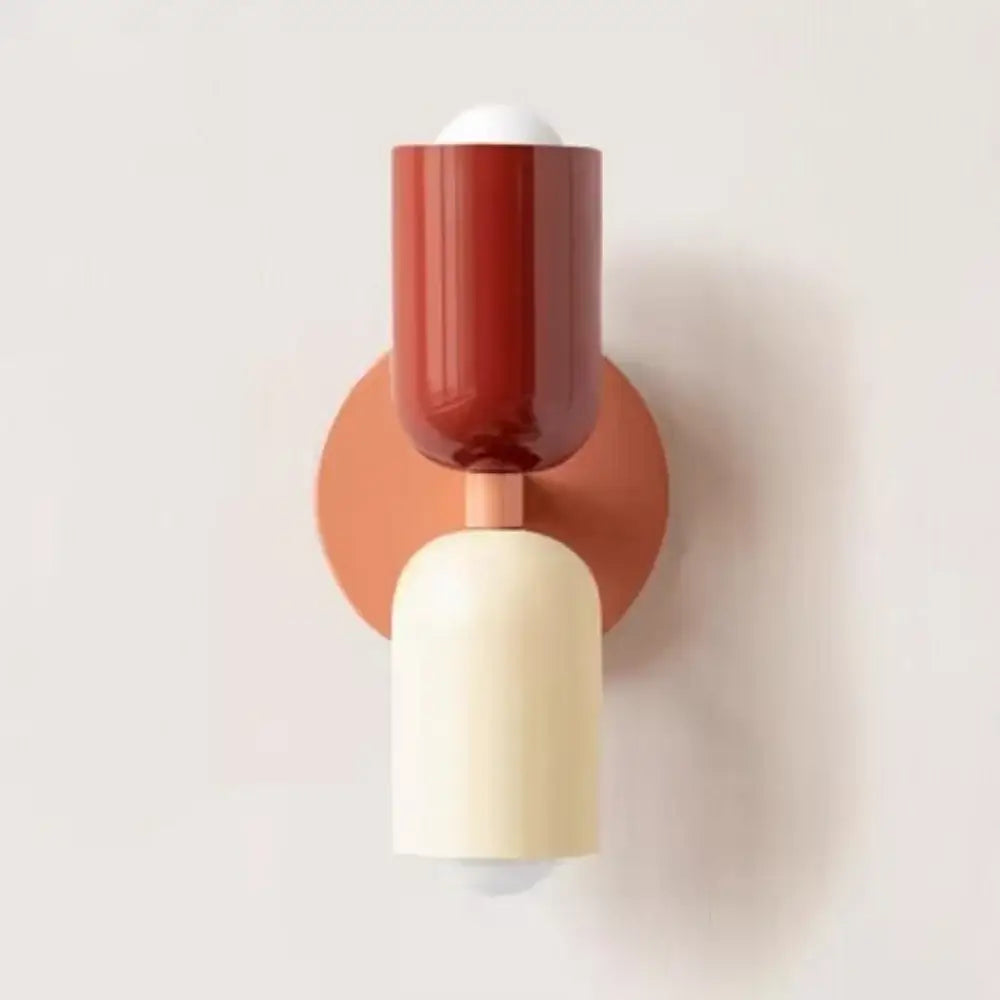 A modern decorbites cream double head wall lamp with matte terracotta base and rust-red glossy upper section for bedroom