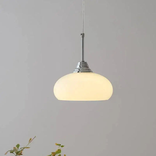 A decorbites cream glass oval pendant light with frosted glass shade and polished chrome hardware for dining room use