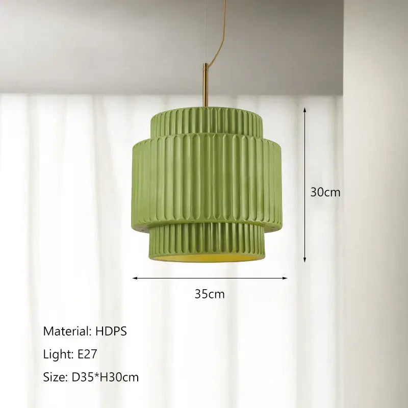 A modern two-tiered green pendant light with vertical ridges and brass rod in decorbites cream wind led chandelier style