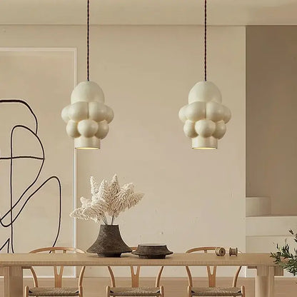 Off-white creamy wind led cloud pendant lights with matte finish hang from dark cords for dining room by decorbites