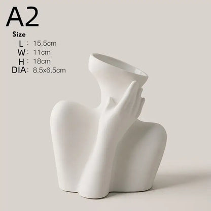 White ceramic sculpture of a hand gently cradling the neck of a ceramic human vase for home decor by DecorBites™