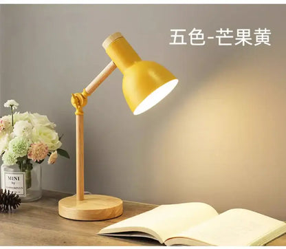 Yellow metal nordic table lamp with wooden base and adjustable arm for bedside desk and reading use