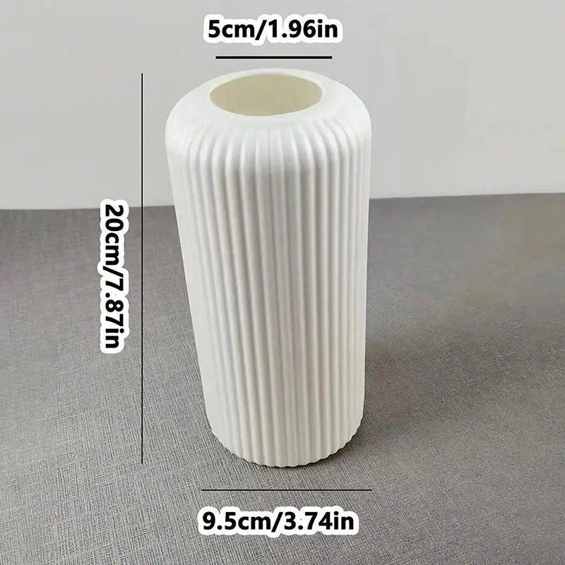 A sleek white plastic flower vase with vertical ribbed texture for elegant floral arrangements by DecorBites™
