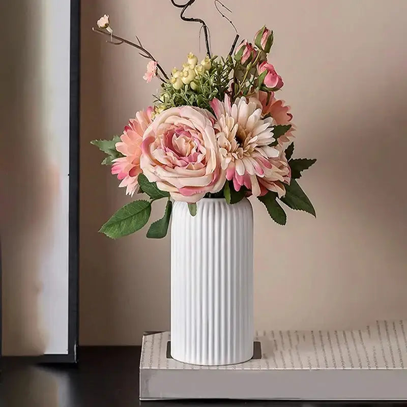 White ribbed ceramic flower vase from DecorBites™ holding pink and cream artificial floral arrangements