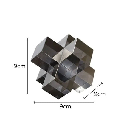 A sleek 9cm cube polished metallic decorbites cross crystal black geometric interlocking sculpture for living room decor