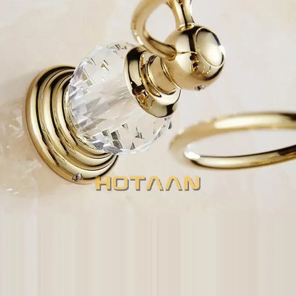 Gold-toned crystal curtain ring with polished brass base and spherical handle for decorbites crystal bathroom hair dryer spiral stand