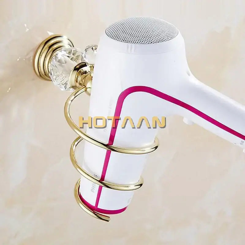 White hair dryer with magenta accent mounted in gold-toned decorbites crystal bathroom spiral stand holder