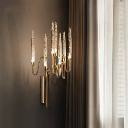 Gold-toned decorbites crystal branch chandelier with six textured glass arms emitting warm light for dining room use
