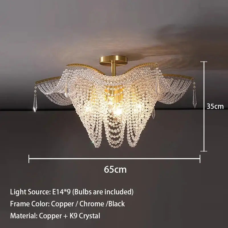 A luxurious decorbites crystal butterfly gold tassel chandelier with clear k9 crystals and copper frame for living rooms