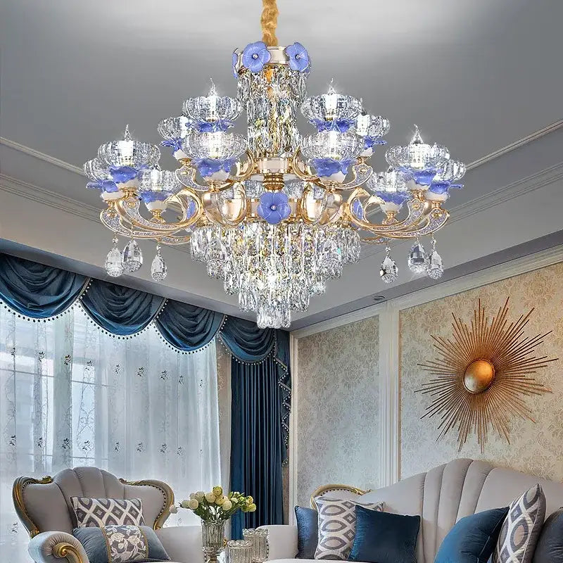 A decorbites crystal candle chandelier with gold metal arms, clear crystals, and blue glass flower accents for living rooms