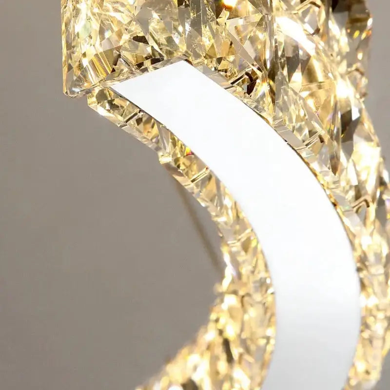 Decorbites crystal ceiling chandelier with modern curved white metal frame and faceted golden crystals for indoor lighting