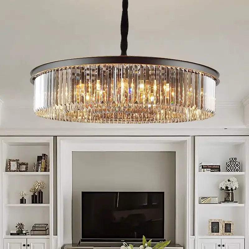 Decorbites crystal ceiling chandelier with dark metal frame and clear crystal prisms emitting warm golden light