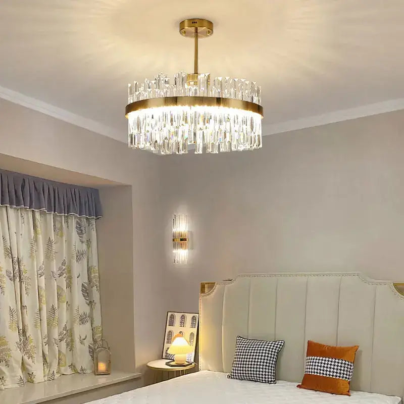 A modern decorbites crystal ceiling chandelier with gold metal frame and clear glass prisms for living and dining rooms