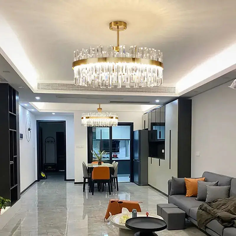 Gold-toned decorbites crystal ceiling chandelier with cascading clear prisms for living and dining rooms lighting