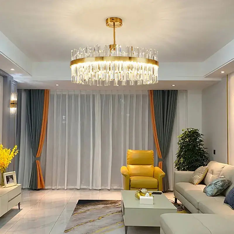 Gold-toned decorbites crystal ceiling chandelier with cascading clear crystal prisms for living and dining rooms