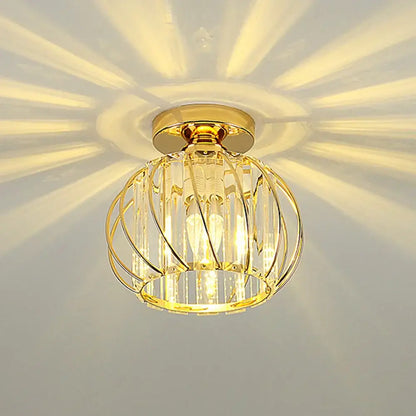 Decorbites crystal ceiling lamp gold-toned spherical cage design with metallic rods and clear prisms emitting warm light