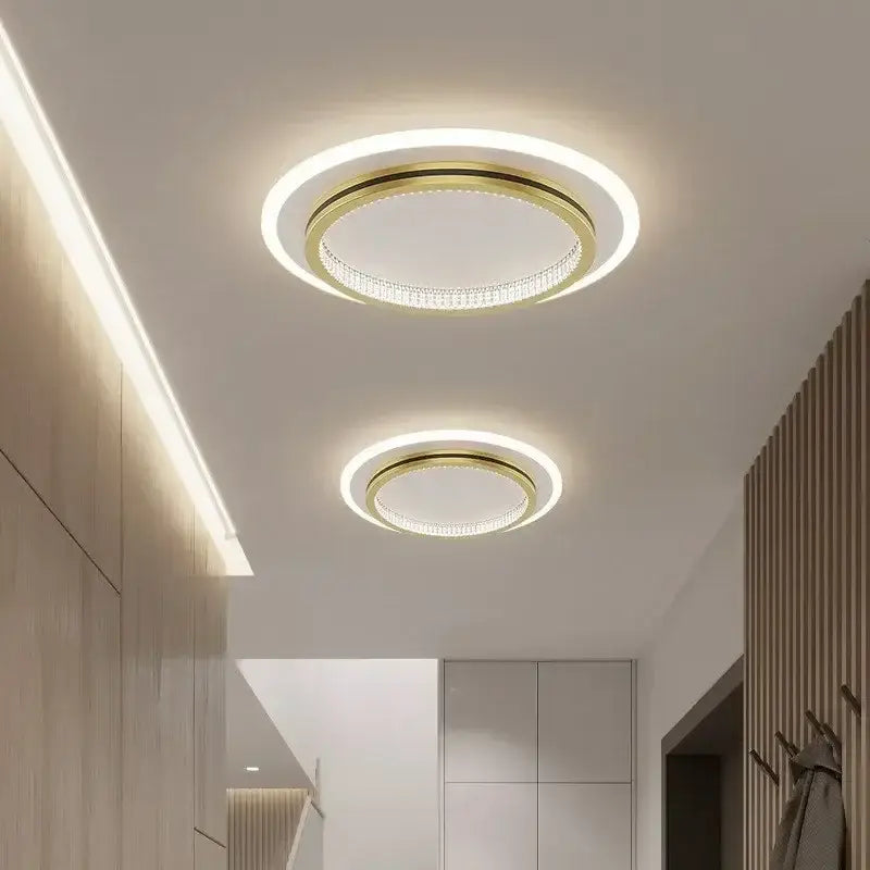 Modern decorbites crystal ceiling light with gold-toned frame, crystal-encrusted ring, and bright white led illumination