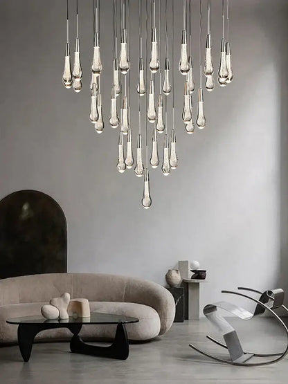 Modern decorbites crystal ceiling pendant lights feature teardrop-shaped glass elements on metallic rods ideal for dining rooms