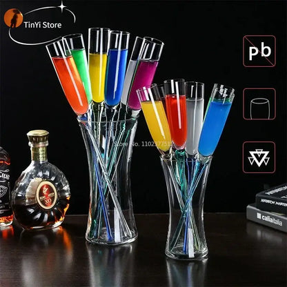 Set of colorful decorbites crystal champagne wine glasses filled with vibrant liquids arranged in clear glass vases