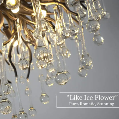 A gold-toned decorbites crystal chandelier with cascading clear glass teardrop pendants for living room and dining table