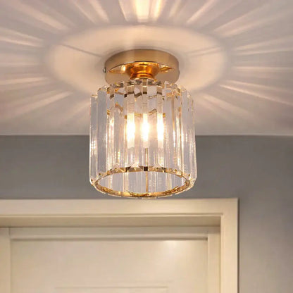 A gold-toned decorbites crystal chandelier ceiling light with clear faceted prisms for modern living room decor
