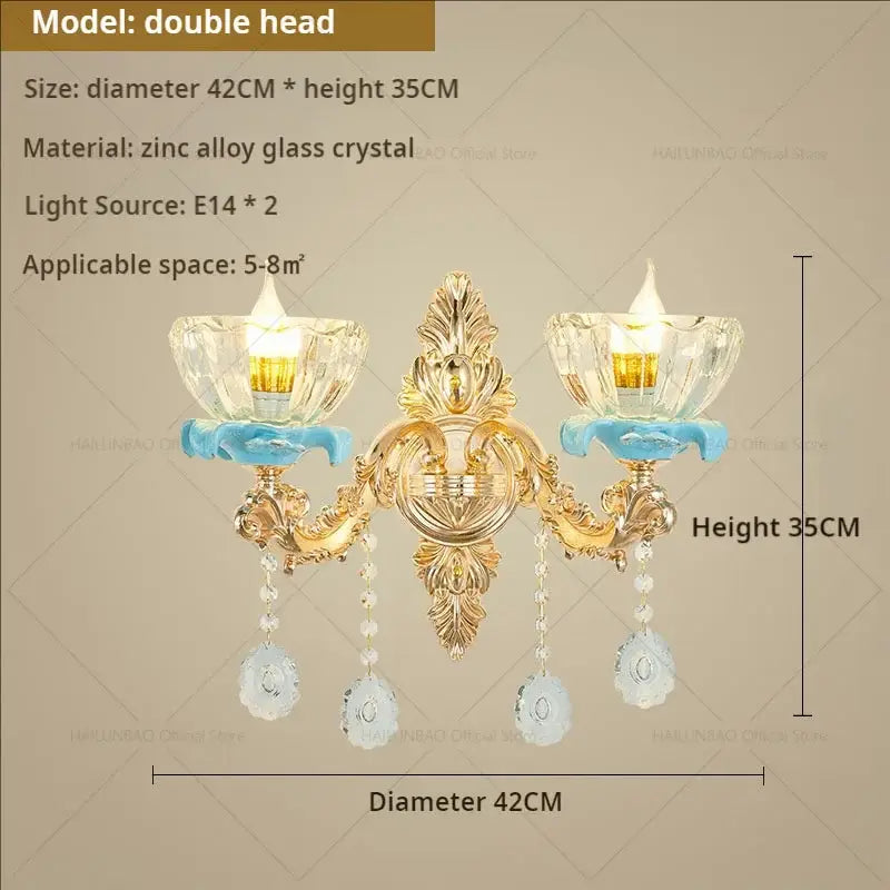 Gold-toned double-headed wall sconce with ornate metalwork and crystal glass shades from decorbites crystal chandelier collection