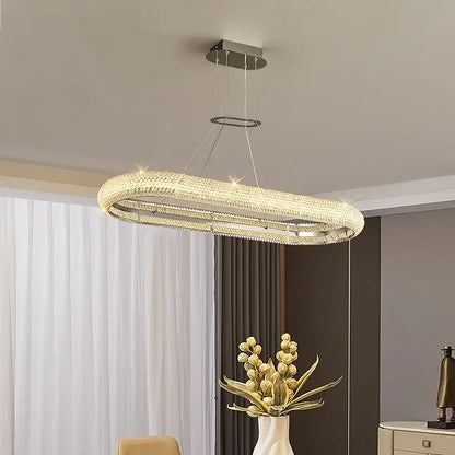 Modern luxury crystal chandelier by decorbites with a sleek chrome frame and embedded crystals emitting warm light