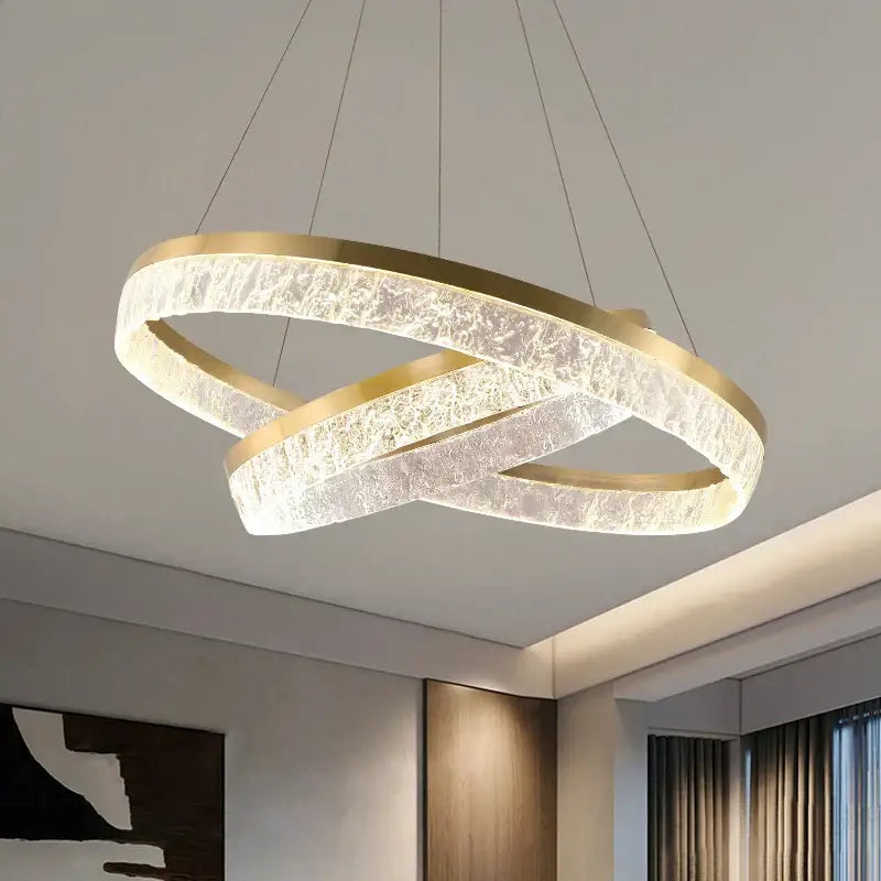 Modern gold-toned decorbites crystal chandelier circular pendant light with textured glass emitting warm white light