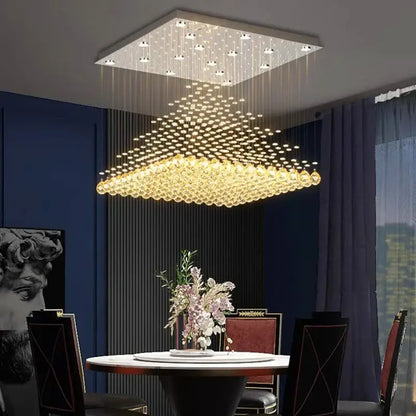 A decorbites crystal chandelier with cascading golden crystal beads and a sleek white frame for indoor ceiling use