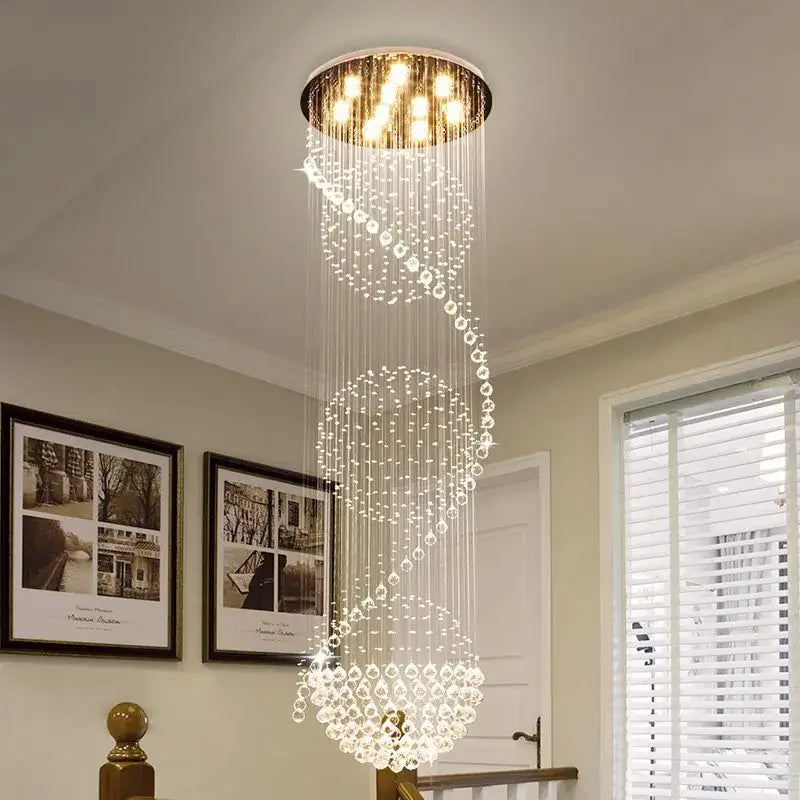 A modern decorbites crystal chandelier with cascading crystal droplets and a gold-toned ceiling fixture for hotels and villas