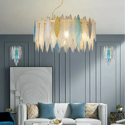 A modern decorbites crystal chandelier with cascading translucent glass leaf shades in gold and blue for elegant interiors