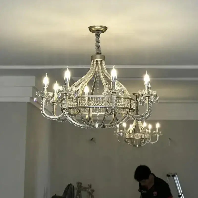 An ornate decorbites crystal chandelier with silver metal frame and clear crystals for elegant living spaces