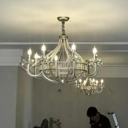 An ornate decorbites crystal chandelier with silver metal frame and clear crystals for elegant living spaces