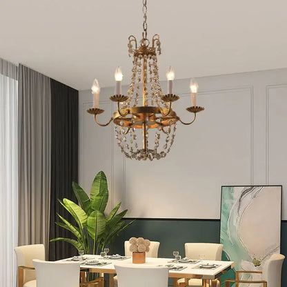 Antique brass decorbites crystal chandelier with dangling crystal droplets and candle-style bulbs for elegant spaces