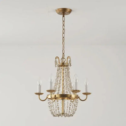 A gold-toned decorbites crystal chandelier with clear crystal beads and five candle-style bulbs for elegant lighting