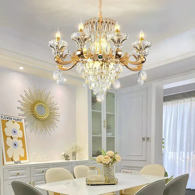Gold-toned decorbites crystal chandelier with intricate droplets and arms adds elegance to dining room lighting