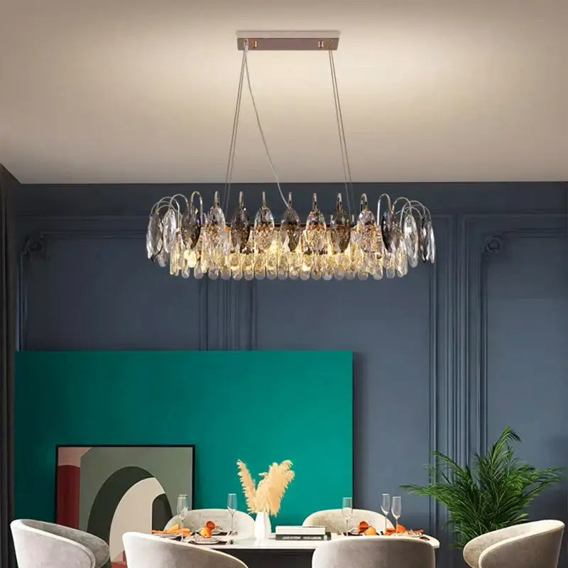 A modern decorbites crystal chandelier pendant light with circular design featuring clear and dark glass elements