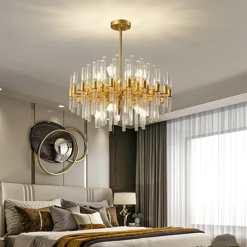 Gold-toned decorbites crystal chandelier with clear glass rods and cylindrical accents for elegant pendant lighting