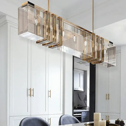 Gold-toned decorbites crystal chandelier featuring vertical crystal prisms and exposed bulbs for elegant interior decoration