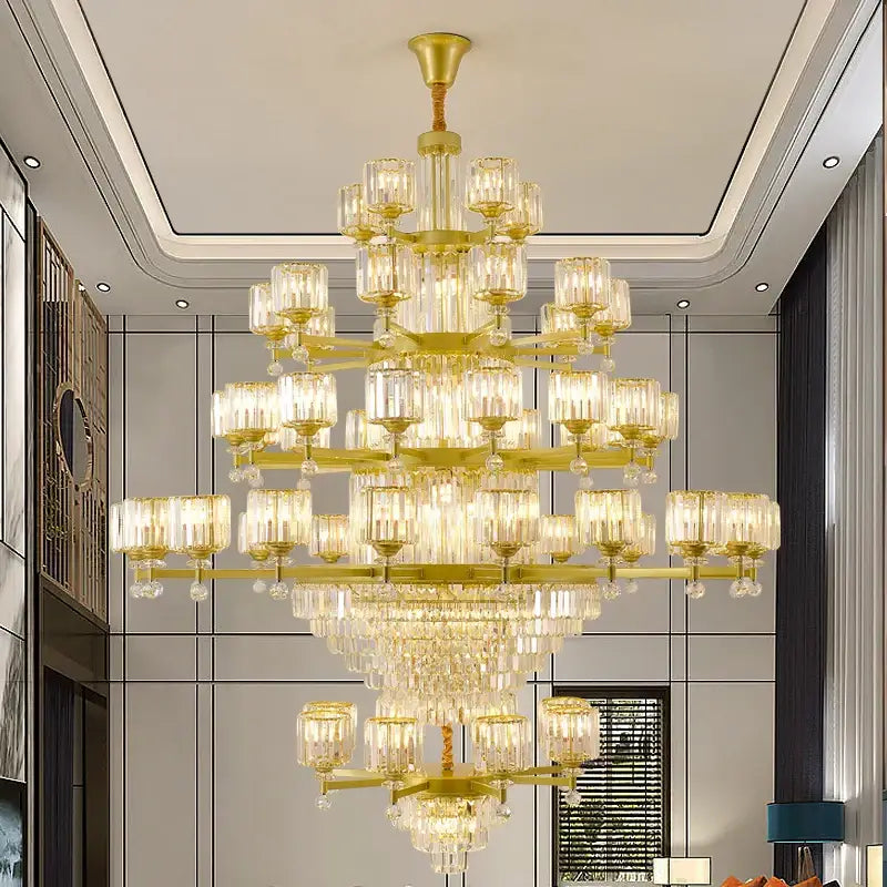 A multi-tiered golden decorbites crystal chandelier with clear glass shades and dangling crystals for elegant lighting