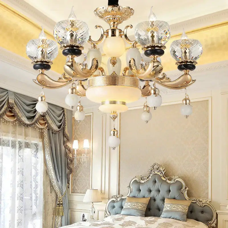 Gold-toned decorbites crystal chandelier with crystal and frosted glass shades for elegant living dining and bedroom spaces