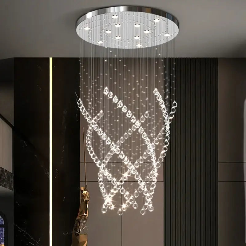 A decorbites crystal chandelier with a sleek chrome base and clear faceted crystals for high ceilings