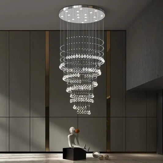 A modern chrome top decorbites crystal chandelier with cascading clear droplets for high ceilings living rooms