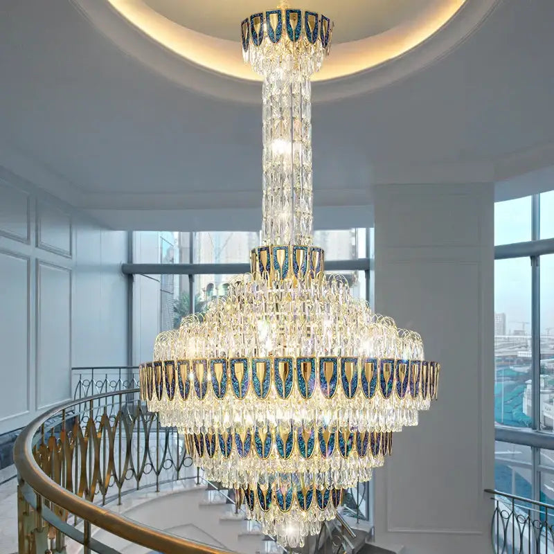 DecorBites crystal chandelier with gold-toned metal and iridescent blue accents in high-end duplex living room